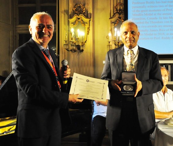 A picture of Prof. Reddy receiving the inaugural JN Reddy Medal from Dr. Erasmo Carrera